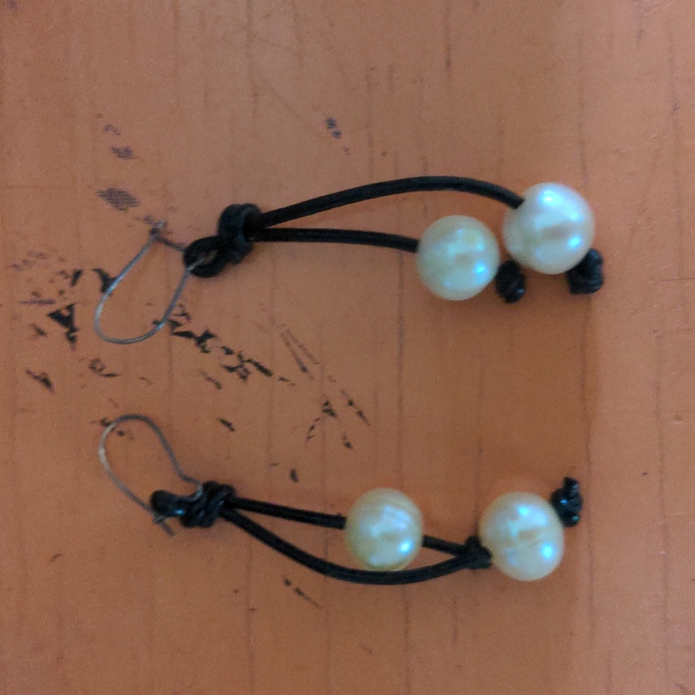Pearl drop earrings on black leather cords